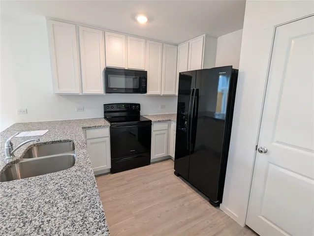 a kitchen with a refrigerator sink and microwave