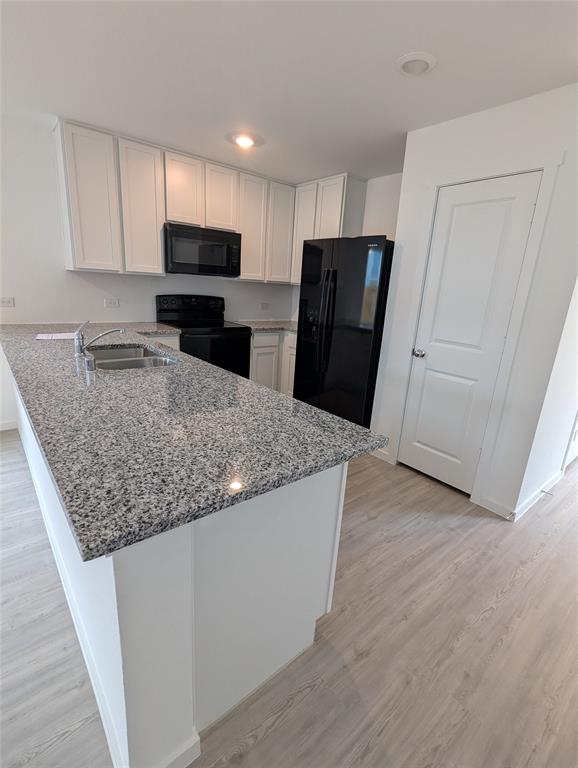 904 Wood Stork Way Princeton, TX 75407 - Photo 14 of 40 a kitchen with granite countertop a refrigerator and a sink
