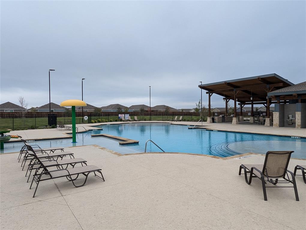904 Wood Stork Way Princeton, TX 75407 - Photo 33 of 40 a swimming pool with outdoor seating and yard
