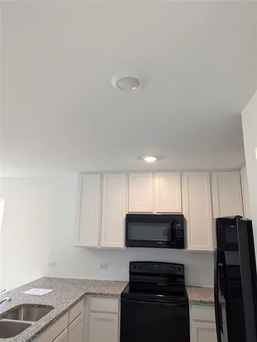 a kitchen with stainless steel appliances a stove a sink and a microwave