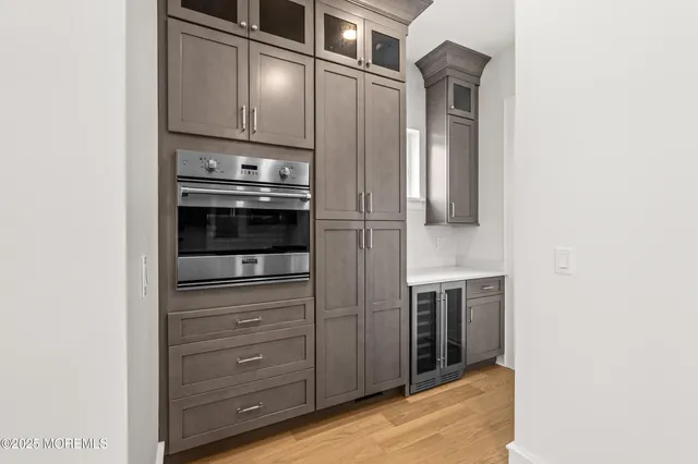 a kitchen with cabinets and stainless steel appliances