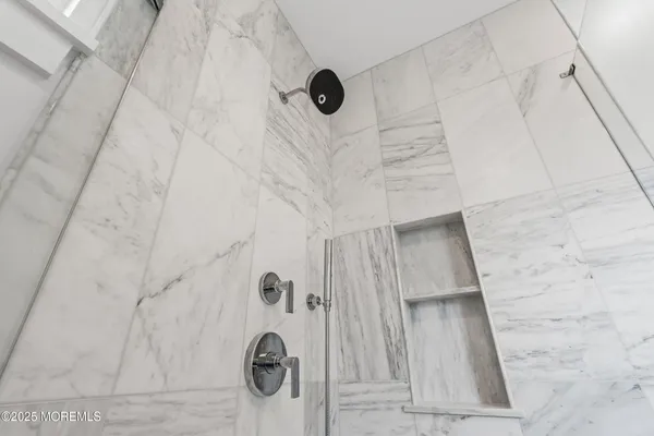 a view of a room with wooden floor and windows