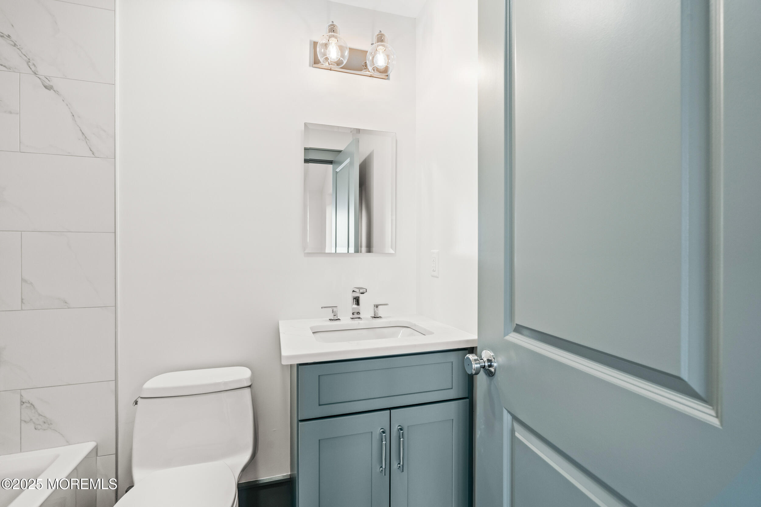 7 South Street Sea Bright, NJ 07760 - Photo 37 of 45 a bathroom with a toilet sink vanity and mirror