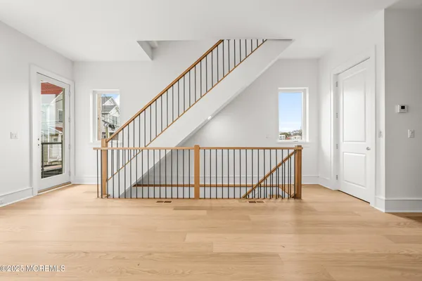 a view of staircase with white floor and a large window