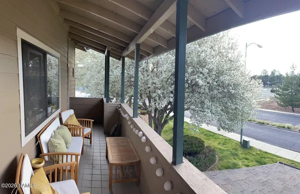 a view of living room with balcony and furniture