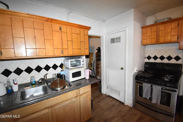 a bedroom with a bed and a flat tv screen on dresser