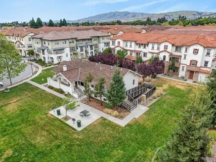 an aerial view of residential house with outdoor space and seating