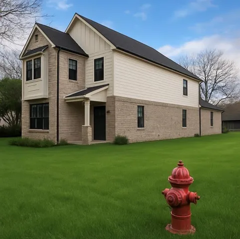 a front view of a house with a garden and yard
