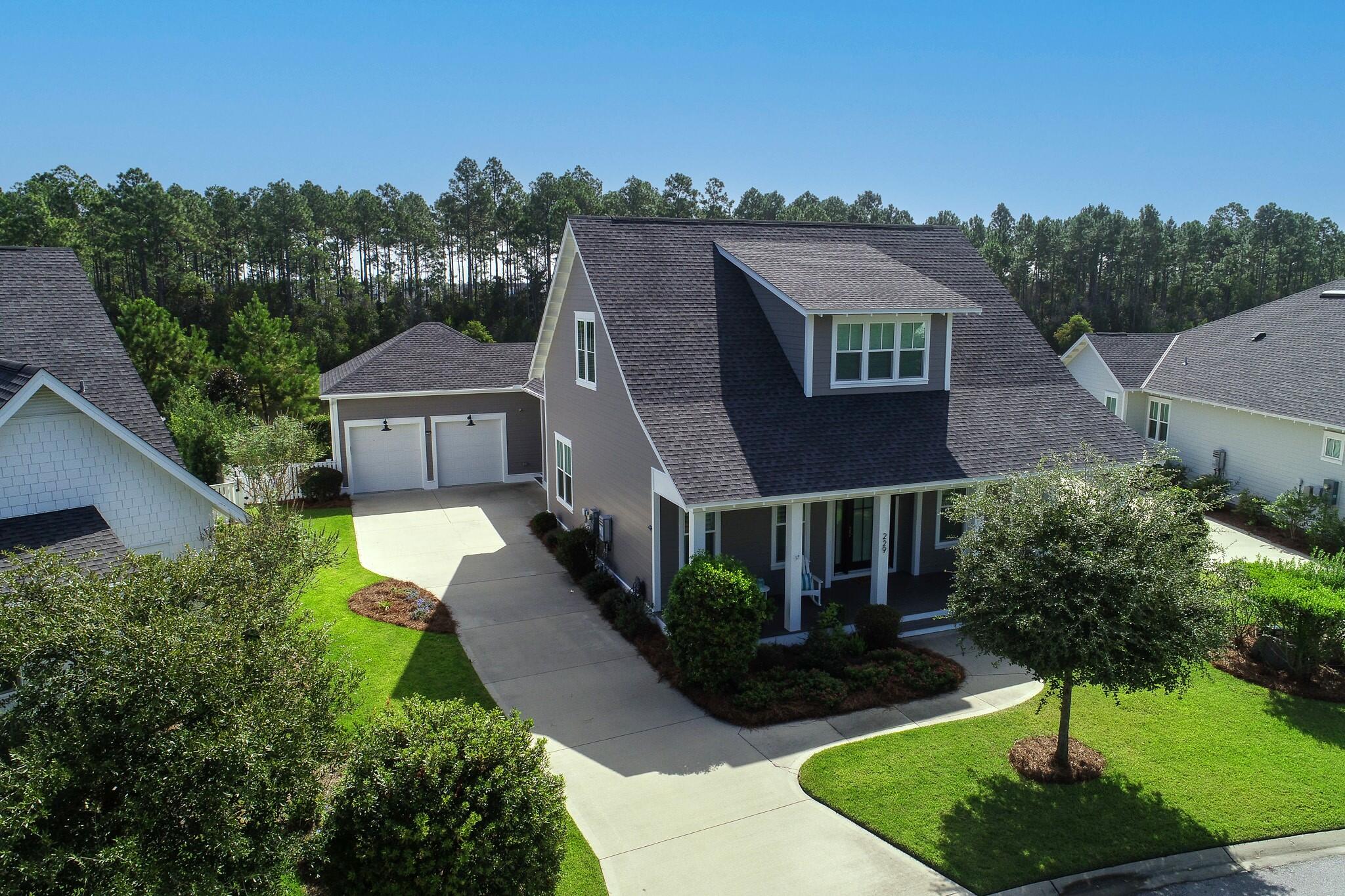 a aerial view of a house with yard and green space