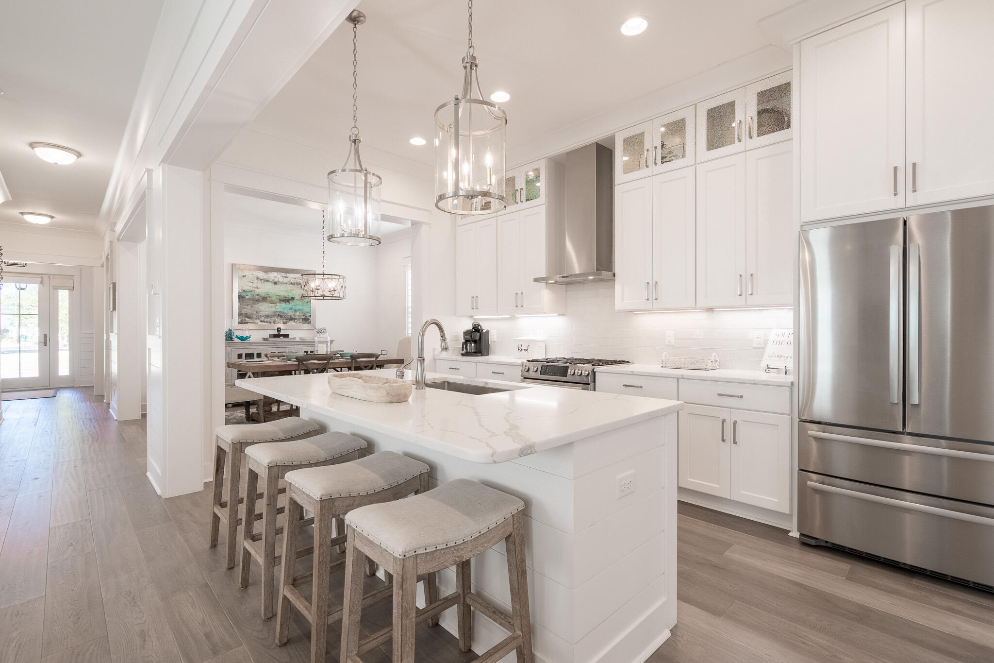 229 Sandchase Circle Inlet Beach, FL 32461 - Photo 12 of 61 a kitchen with stainless steel appliances granite countertop a refrigerator a sink dishwasher a stove a dining table and chairs with wooden floor