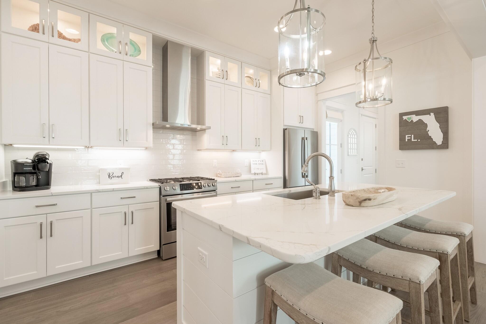 229 Sandchase Circle Inlet Beach, FL 32461 - Photo 13 of 61 a kitchen with a sink stove and white cabinets