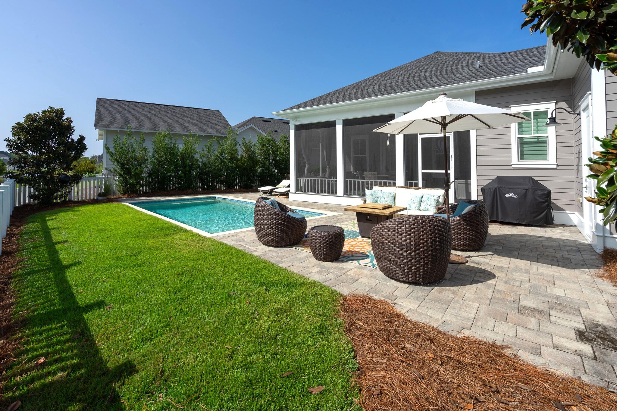229 Sandchase Circle Inlet Beach, FL 32461 - Photo 38 of 61 a view of a house with backyard sitting area and garden