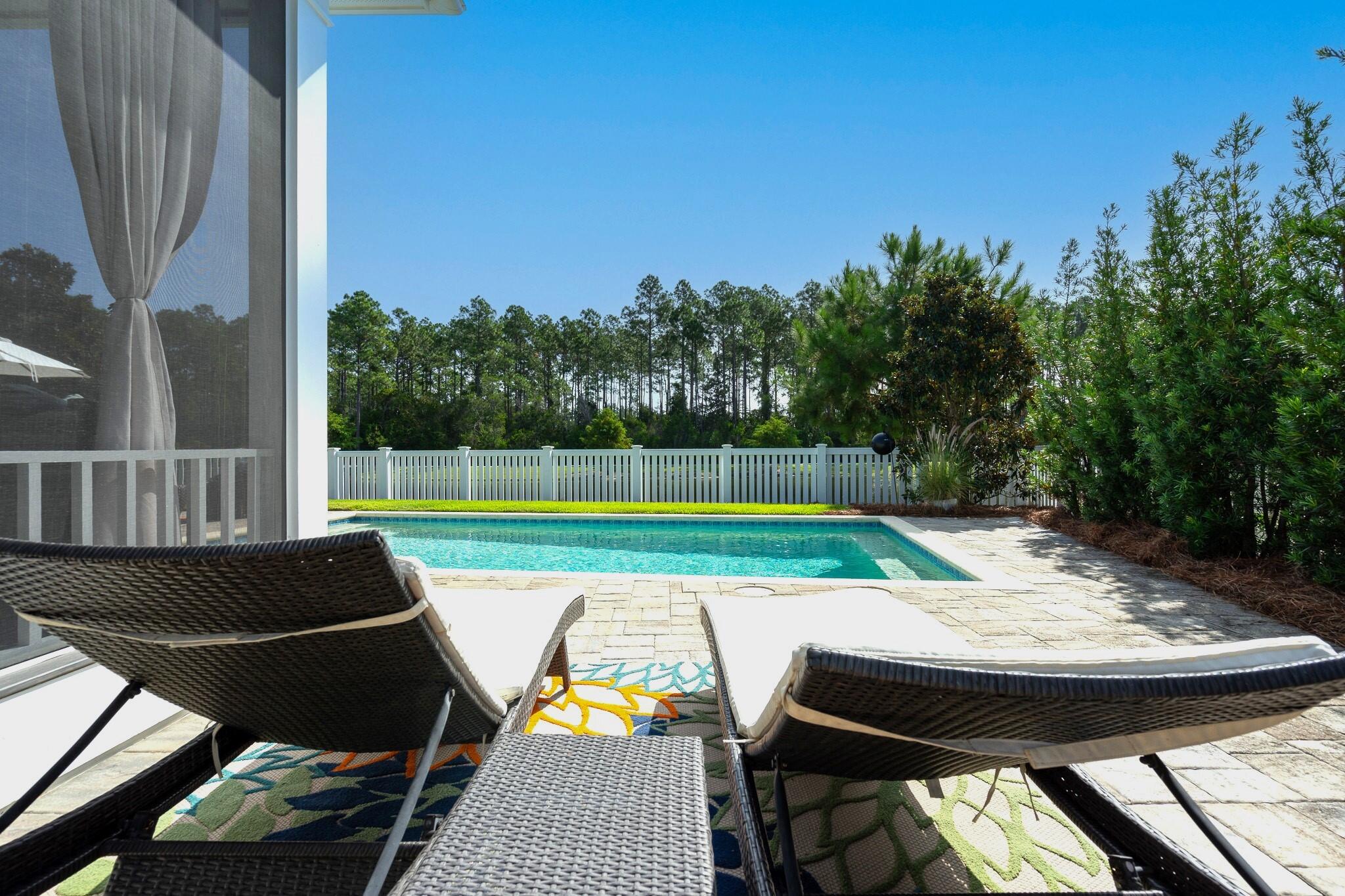 229 Sandchase Circle Inlet Beach, FL 32461 - Photo 40 of 61 a view of a chairs and table on the deck