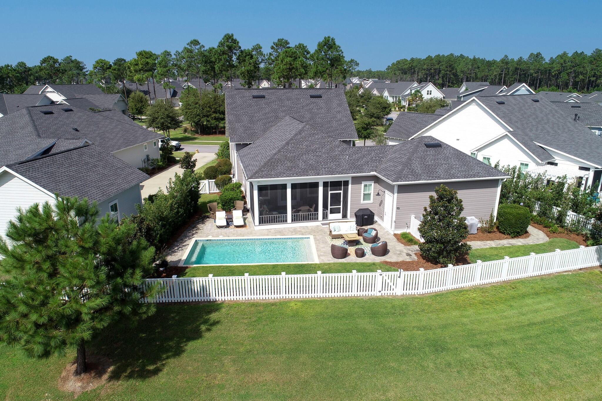 229 Sandchase Circle Inlet Beach, FL 32461 - Photo 47 of 61 front view of a house with a yard table and chairs