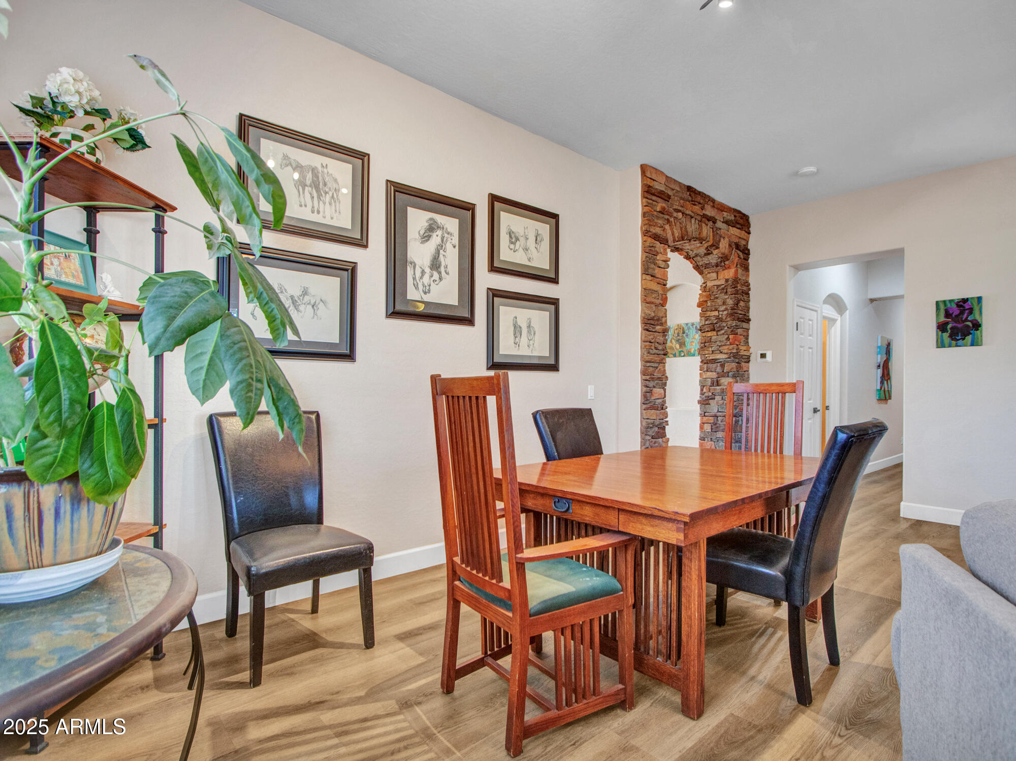 6919 West Rowel Road Peoria, AZ 85383 - Photo 16 of 74 a view of a dining room with furniture window and wooden floor