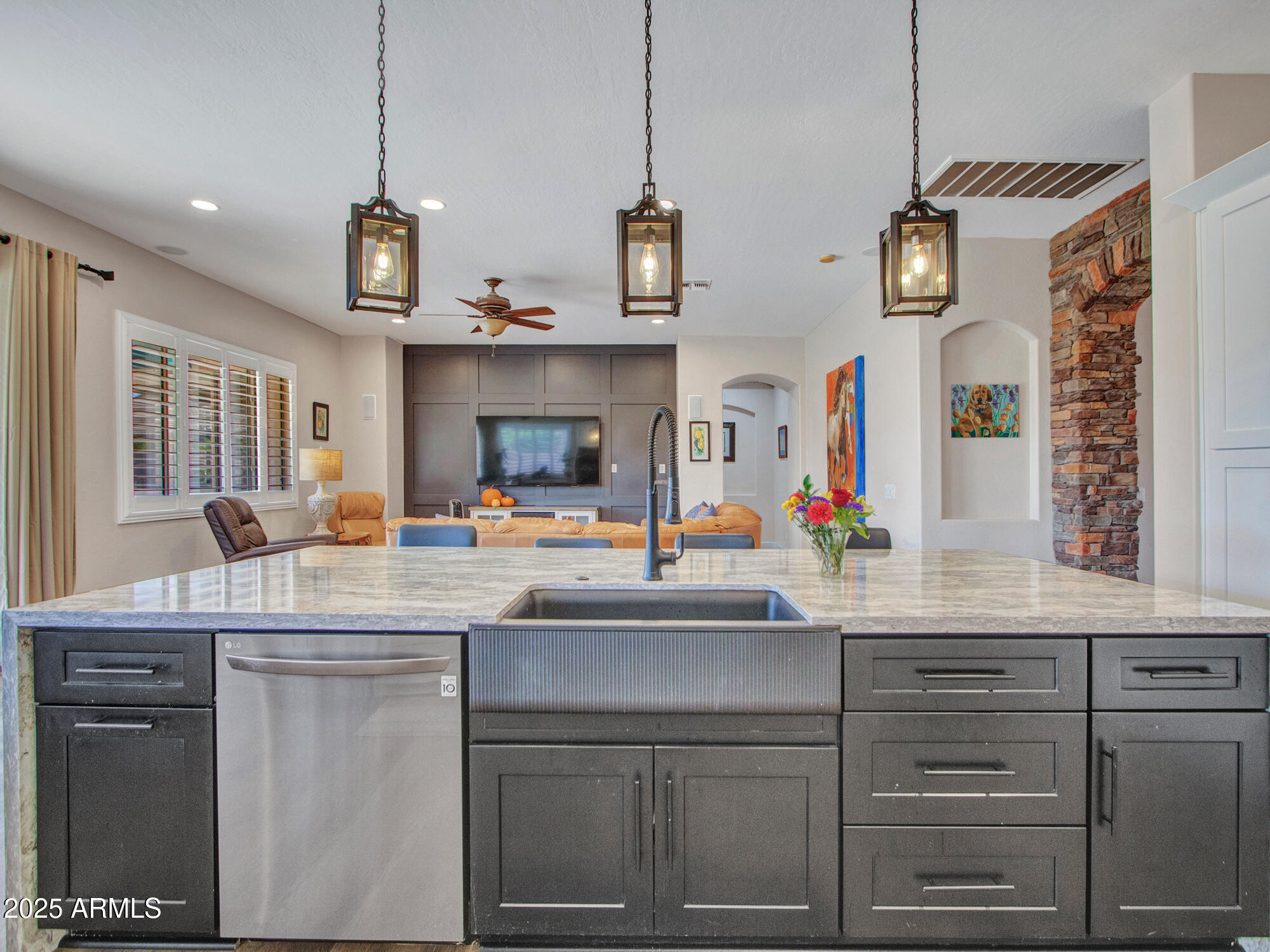 6919 West Rowel Road Peoria, AZ 85383 - Photo 21 of 74 a kitchen with cabinets a sink and dishwasher