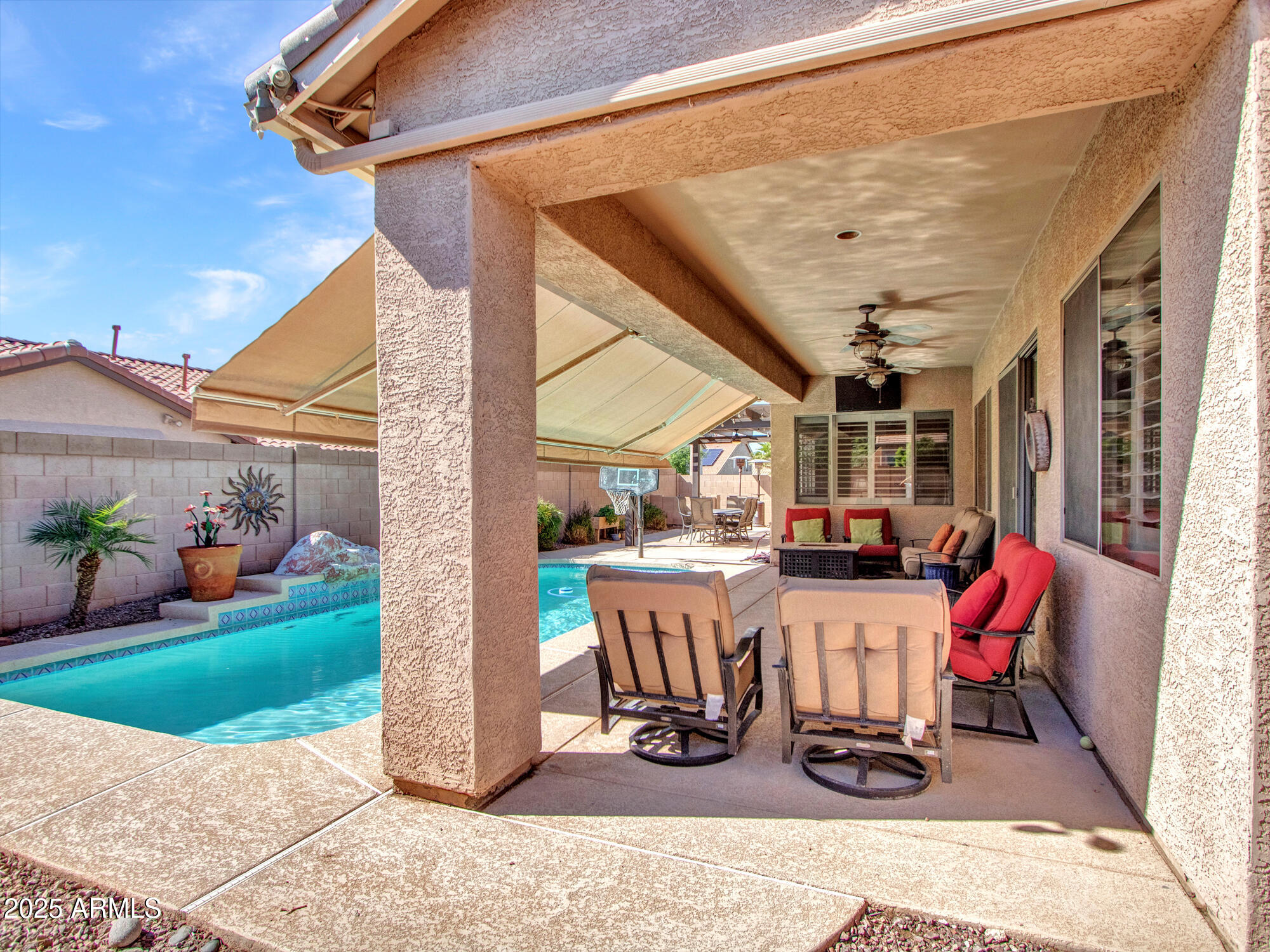 6919 West Rowel Road Peoria, AZ 85383 - Photo 35 of 74 a view of a patio with a dining table and chairs with wooden floor and fence
