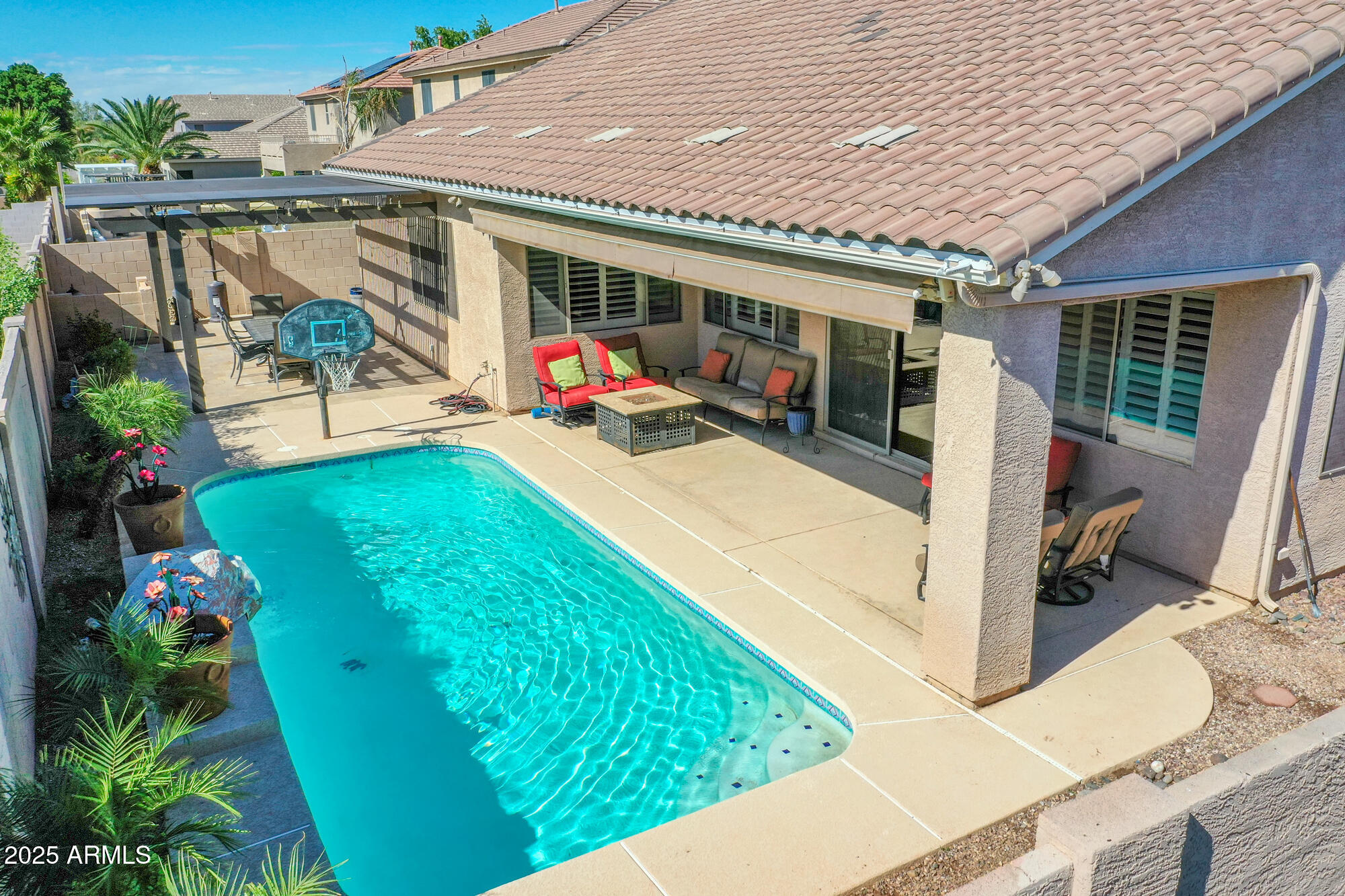 6919 West Rowel Road Peoria, AZ 85383 - Photo 4 of 74 a view of a patio with table and chairs potted plants with wooden floor and seating space