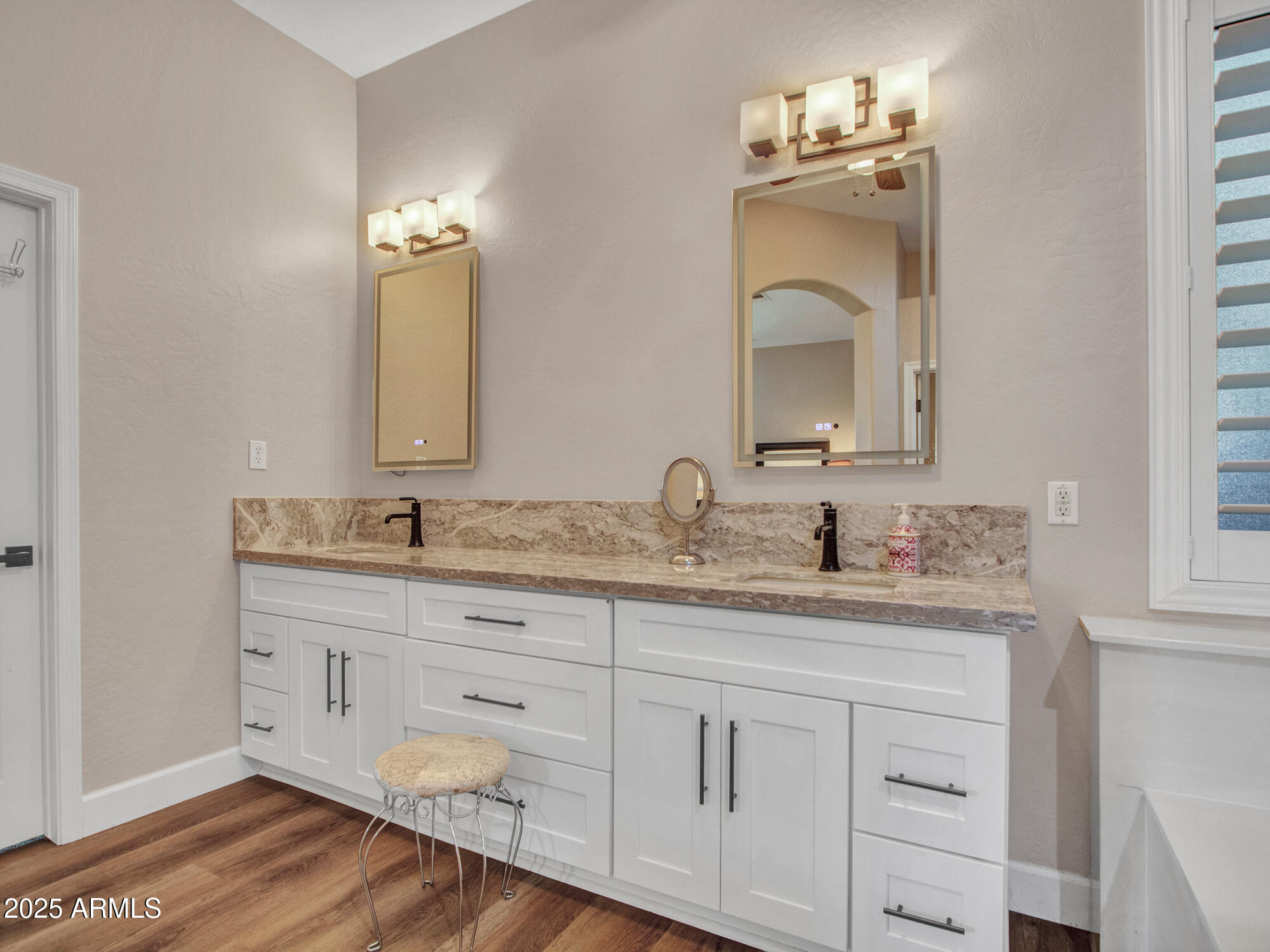 6919 West Rowel Road Peoria, AZ 85383 - Photo 49 of 74 a bathroom with double vanity white cabinets and a mirror