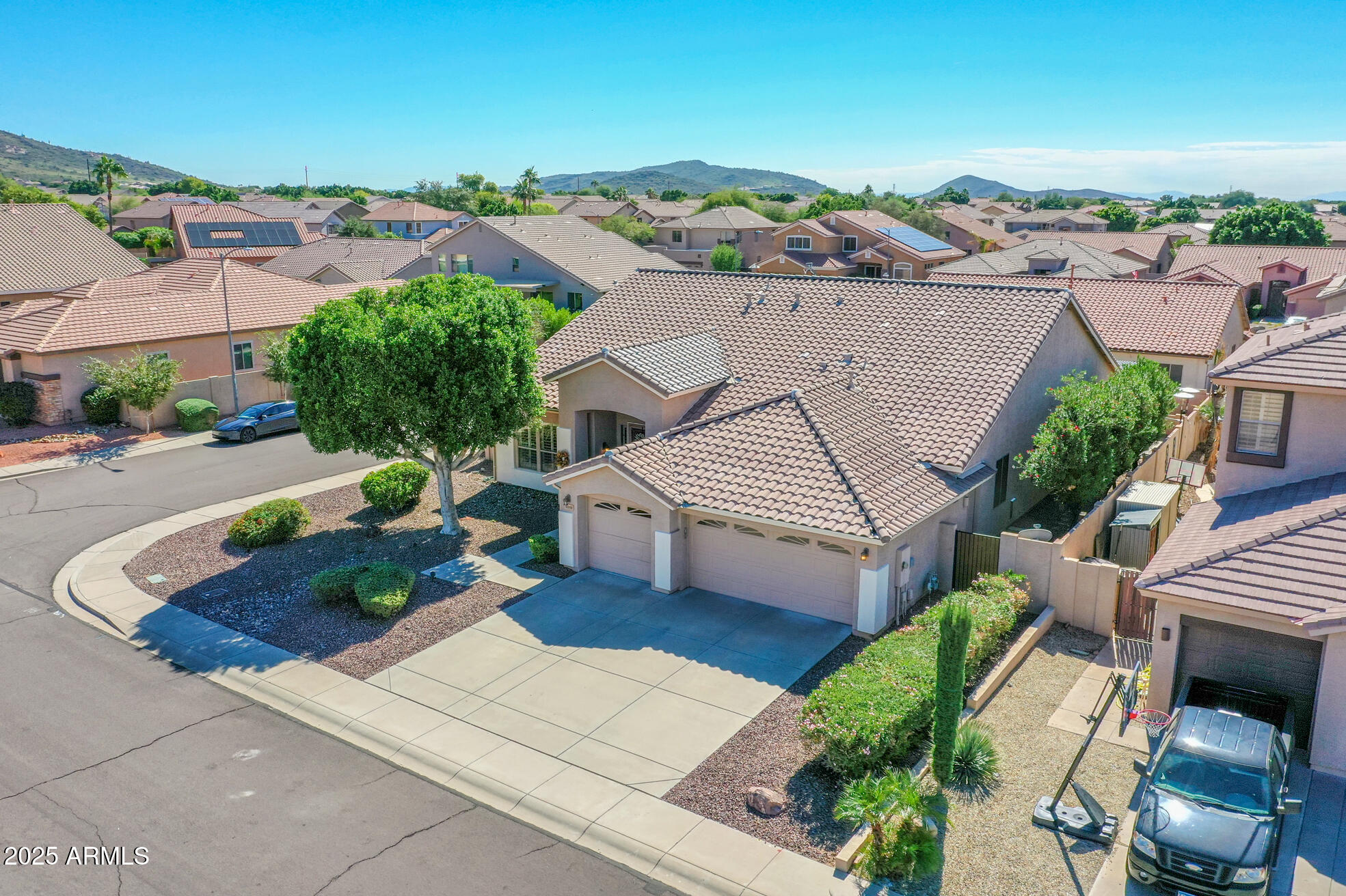 6919 West Rowel Road Peoria, AZ 85383 - Photo 62 of 74 an aerial view of multiple houses with a yard