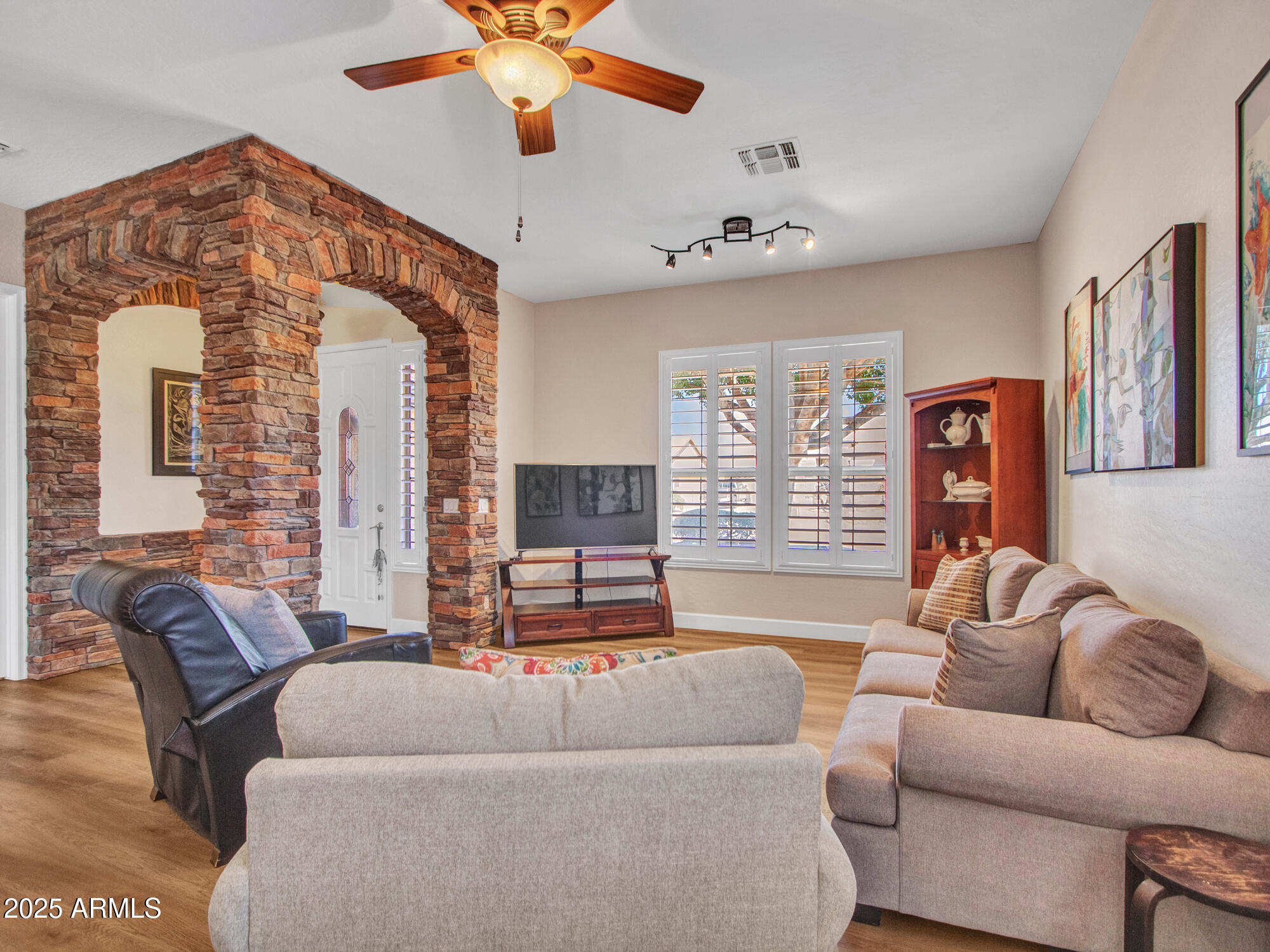 6919 West Rowel Road Peoria, AZ 85383 - Photo 10 of 74 a living room with furniture and a large window