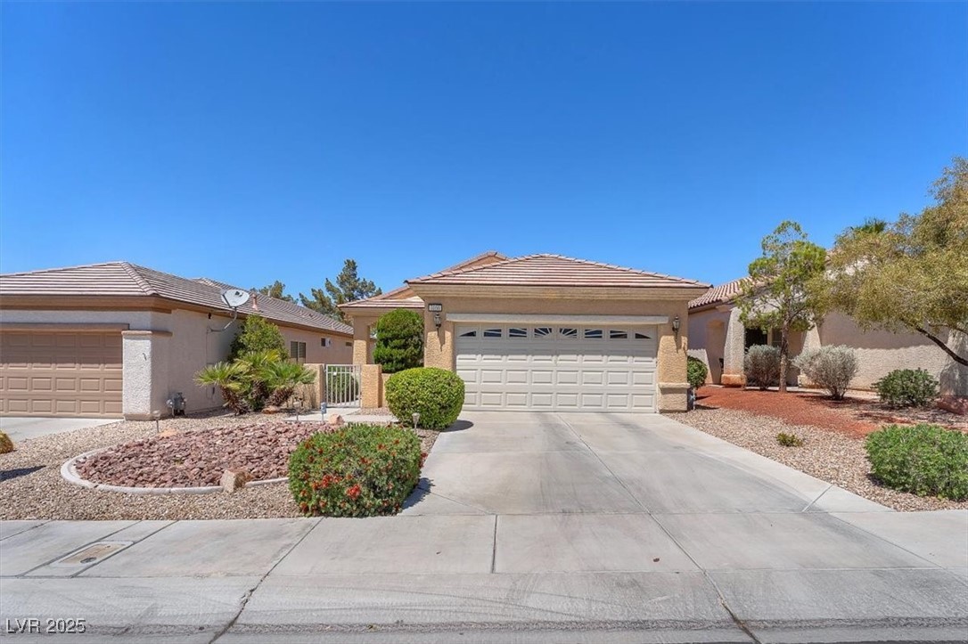 3056 Monroe Park Road Henderson, NV 89052 - Photo 28 of 28 Ranch-style home featuring a garage, stucco siding, a tile roof, and concrete driveway