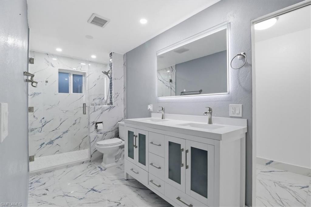 6800 Northwest 28th Avenue Miami, FL 33147 - Photo 15 of 40 Bathroom with double vanity, a marble finish shower, and recessed lighting
