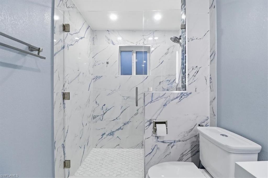 6800 Northwest 28th Avenue Miami, FL 33147 - Photo 16 of 40 Bathroom with a marble finish shower, vanity, and a textured wall