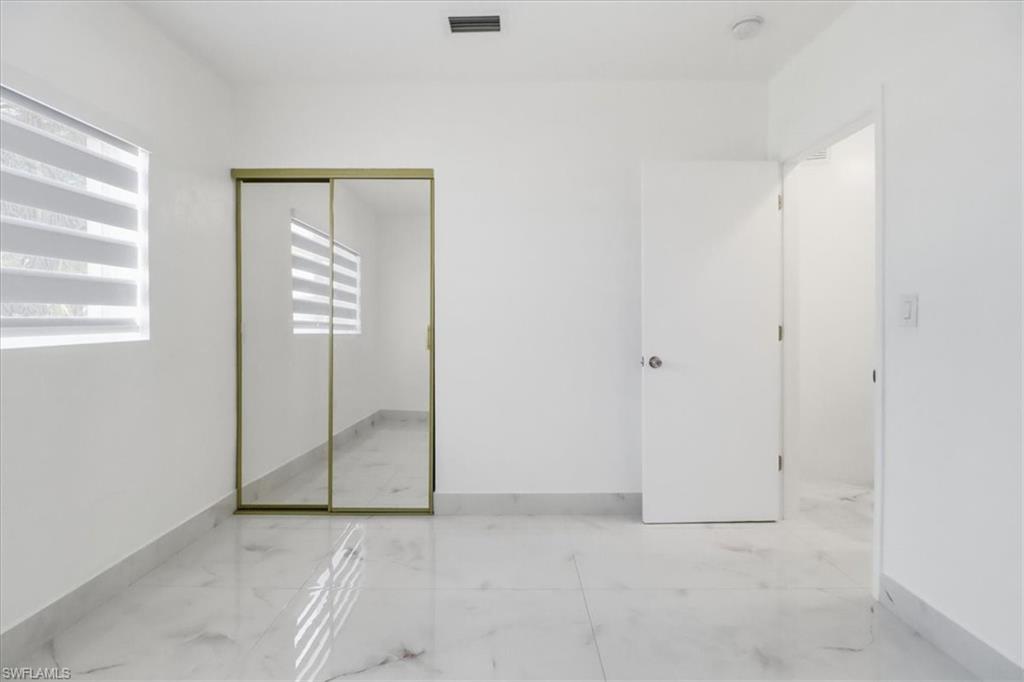 6800 Northwest 28th Avenue Miami, FL 33147 - Photo 24 of 40 Unfurnished bedroom featuring light marble finish floors and a closet