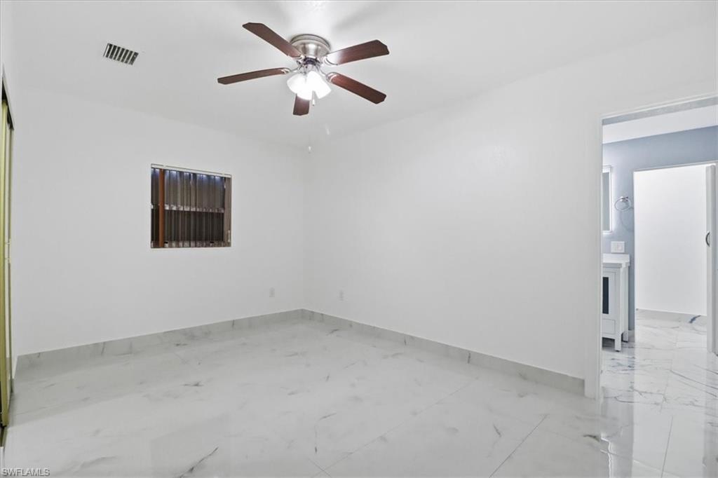6800 Northwest 28th Avenue Miami, FL 33147 - Photo 27 of 40 Unfurnished room featuring ceiling fan and light marble finish floors