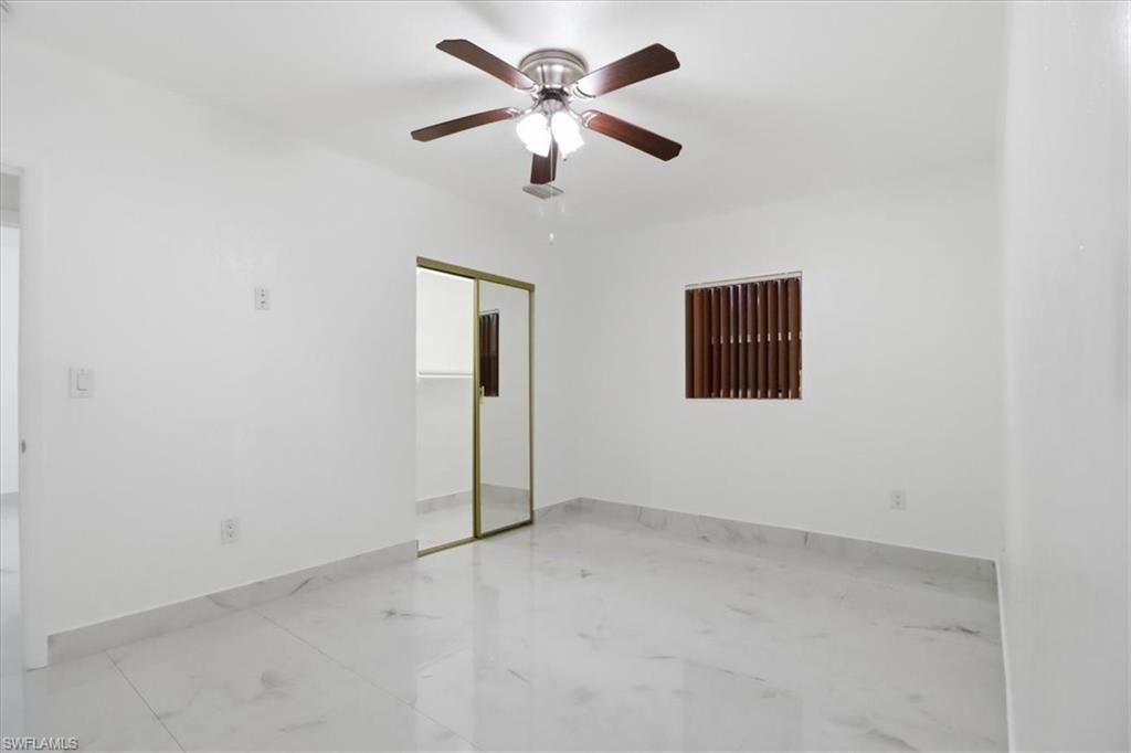 6800 Northwest 28th Avenue Miami, FL 33147 - Photo 28 of 40 Unfurnished bedroom featuring a closet, ceiling fan, and light marble finish floors