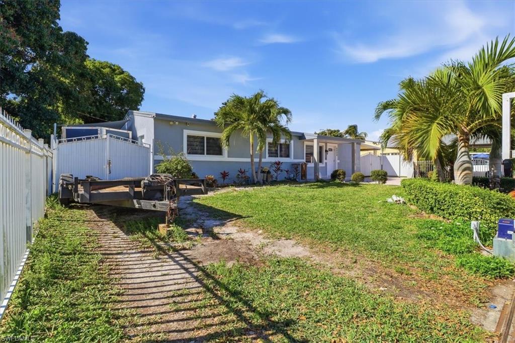 6800 Northwest 28th Avenue Miami, FL 33147 - Photo 4 of 40 View of front facade featuring stucco siding, a gate, and a deck