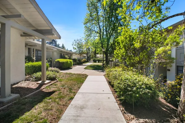 a living room with furniture a floor to ceiling window and a flat screen tv
