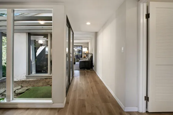 a view of hallway with wooden floor