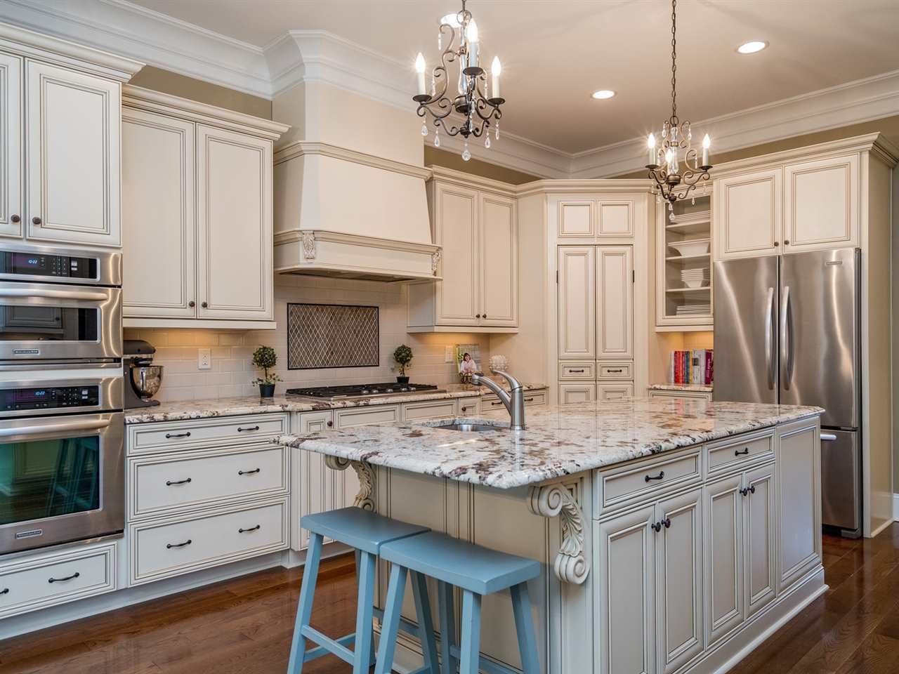 3316 Bryant Falls Court Raleigh, NC 27613 - Photo 4 of 30 42” staggered custom stained cabinets with crown finishing trim and slow close drawers and under cabinet lighting Kitchen