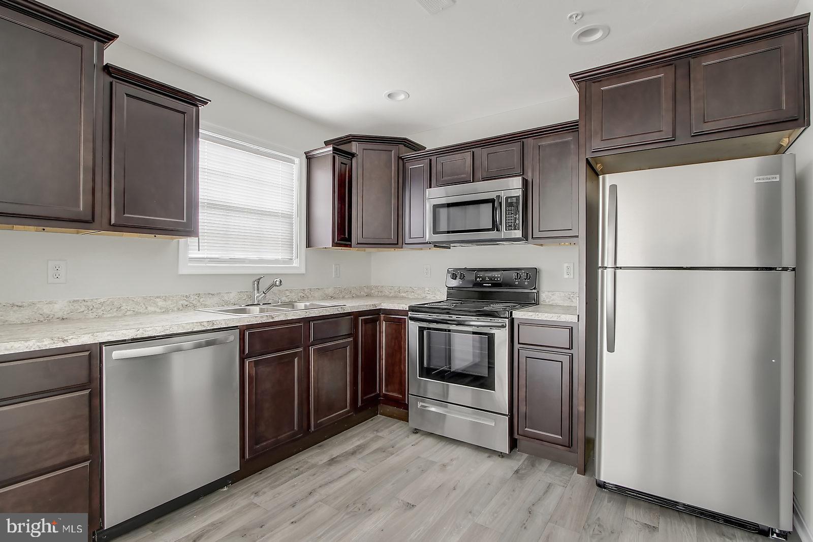 127 Balsam Lane Hanover, PA 17331 - Photo 2 of 11 a kitchen with stainless steel appliances granite countertop a refrigerator stove and sink