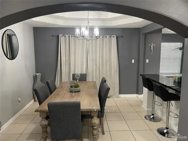 a view of a dining room with furniture and chandelier