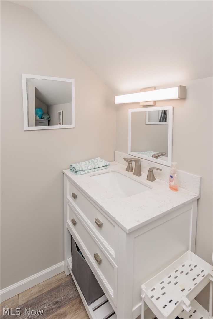 120 Sunset Road Avon Lake, OH 44012 - Photo 25 of 40 Bathroom featuring vaulted ceiling, vanity, and hardwood / wood-style floors