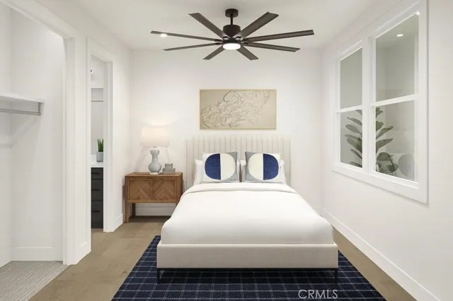 a bedroom with a bed and a window with a potted plant