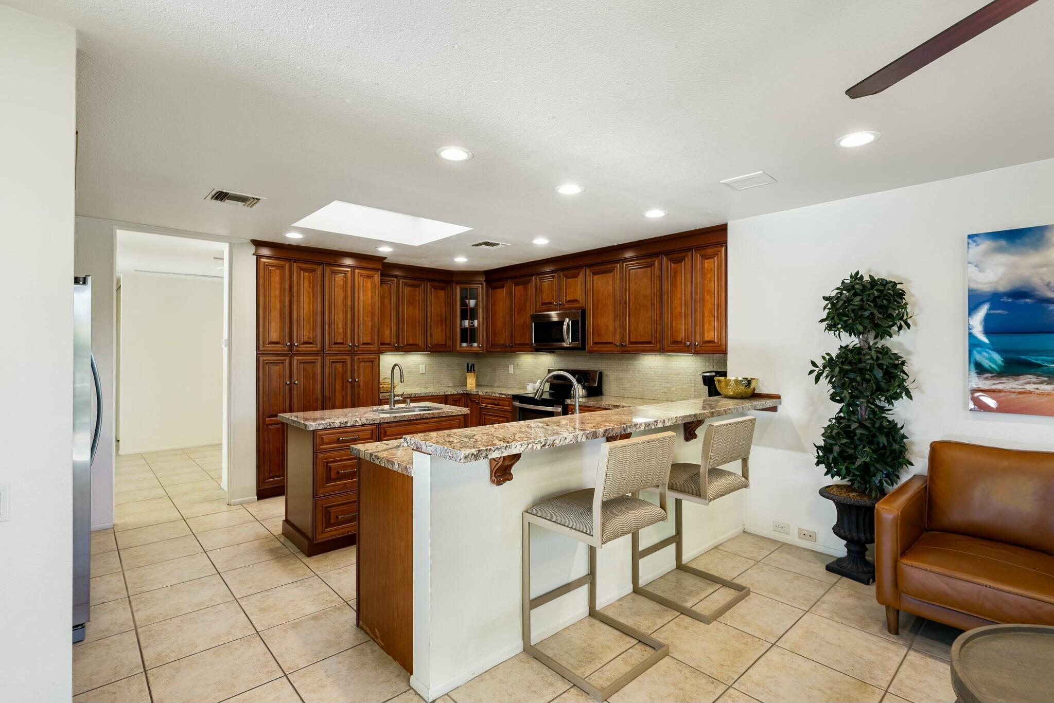 6 Stanford Drive Rancho Mirage, CA 92270 - Photo 15 of 39 a view of kitchen with furniture a refrigerator and a wooden floor