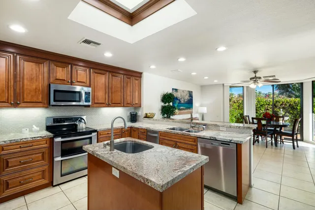 a kitchen with granite countertop a sink and stove
