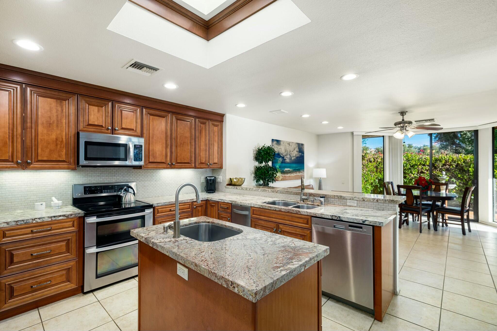 6 Stanford Drive Rancho Mirage, CA 92270 - Photo 17 of 39 a kitchen with granite countertop a sink and stove