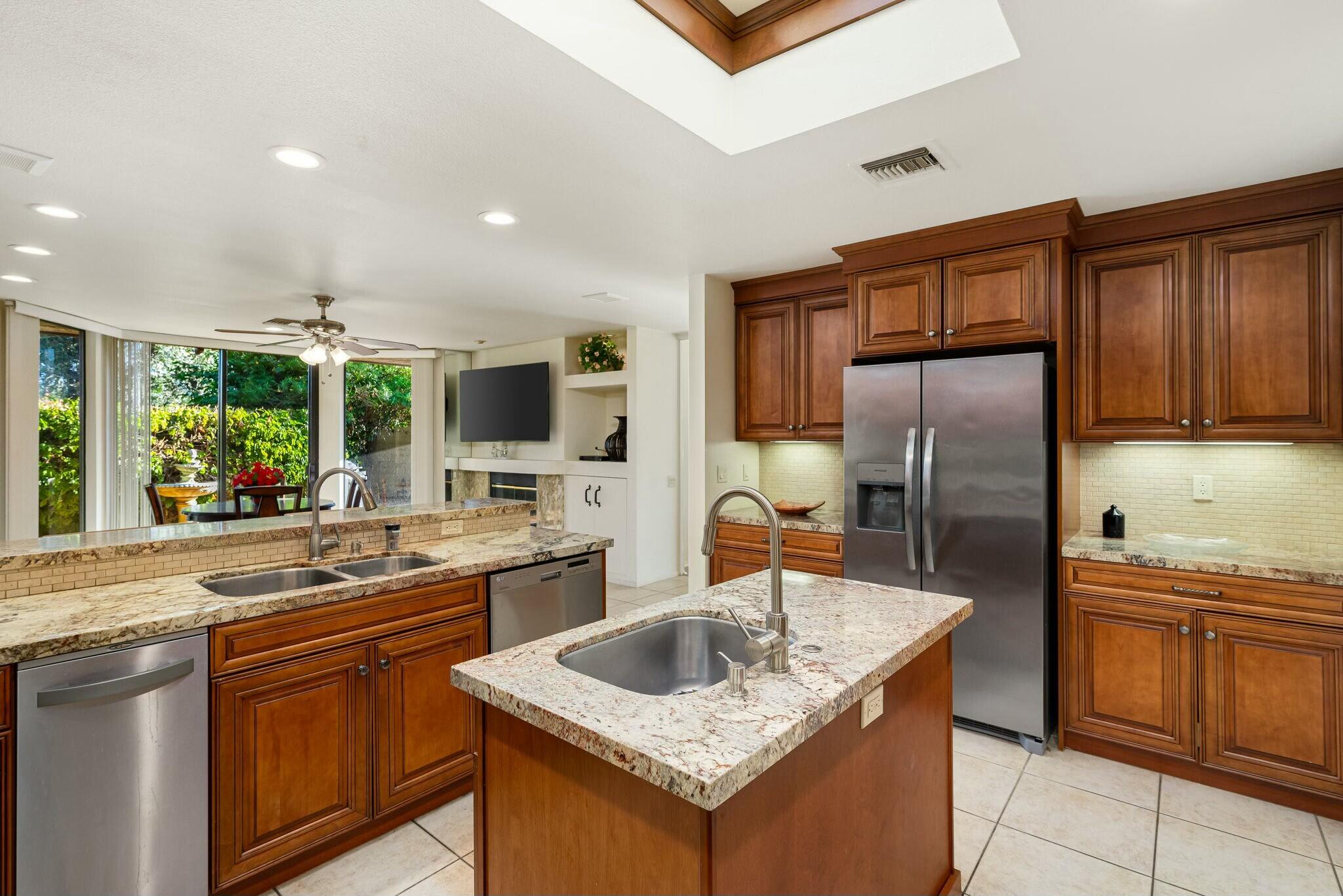 6 Stanford Drive Rancho Mirage, CA 92270 - Photo 18 of 39 a kitchen with stainless steel appliances granite countertop a sink stove and refrigerator