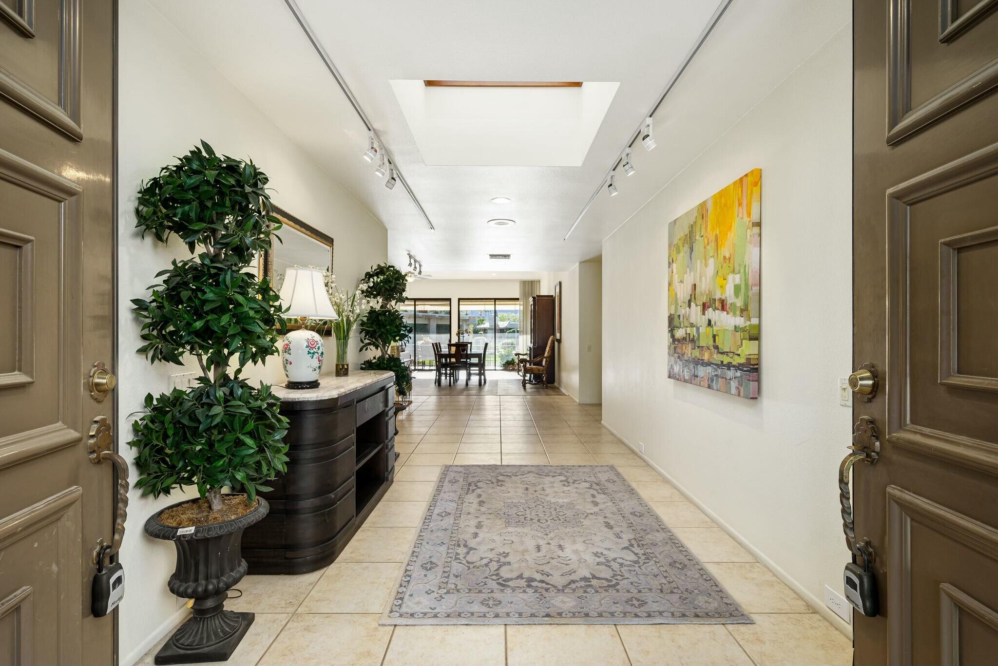 6 Stanford Drive Rancho Mirage, CA 92270 - Photo 2 of 39 a view of a hallway with couch and potted plant