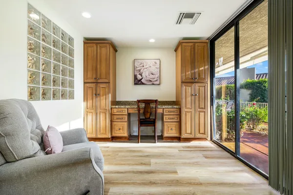 a living room with furniture and large windows