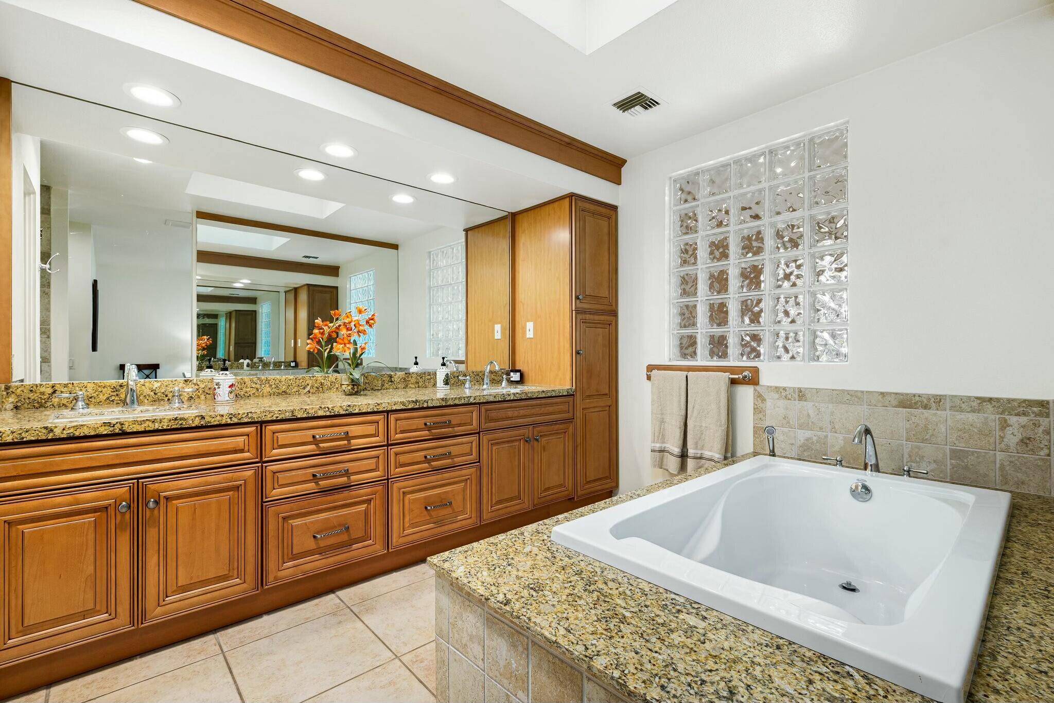 6 Stanford Drive Rancho Mirage, CA 92270 - Photo 22 of 39 a bathroom with a tub sink and mirror