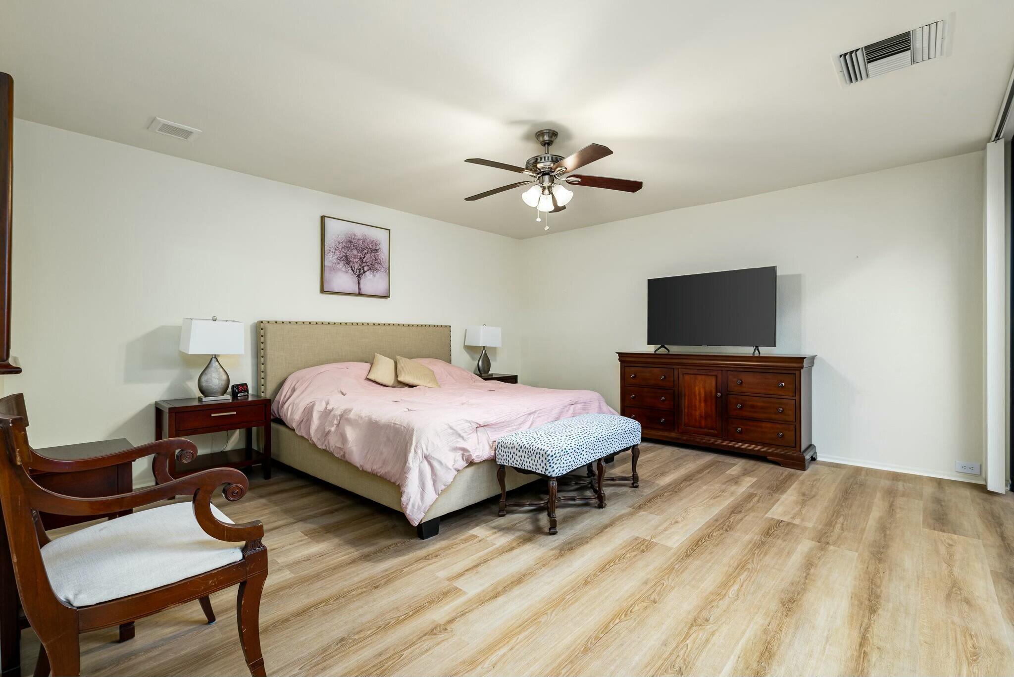 6 Stanford Drive Rancho Mirage, CA 92270 - Photo 24 of 39 a spacious bedroom with a bed and a tv on table