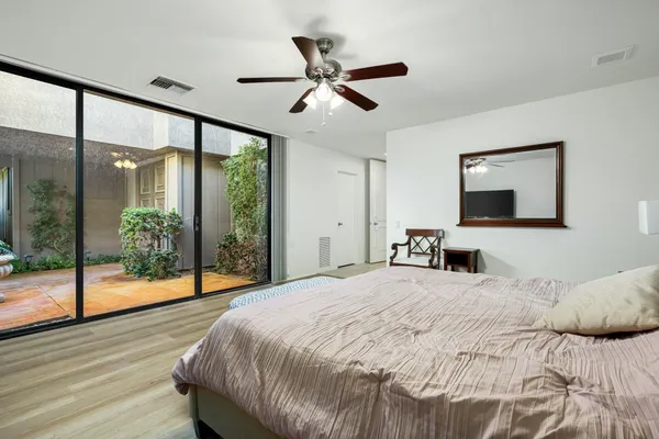 a bedroom with a large bed and a large window