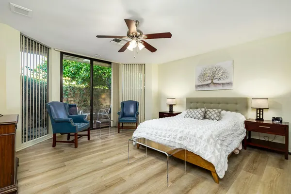 a bedroom with a bed and a large window