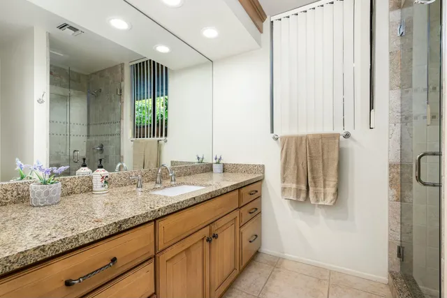 a bathroom with double vanity and a mirror